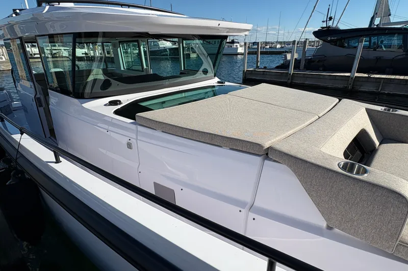 Slide: The Image of 2026 Axopar 37 XC Cross Cabin boat docked at marina, showcasing sleek design and spacious deck. - 7