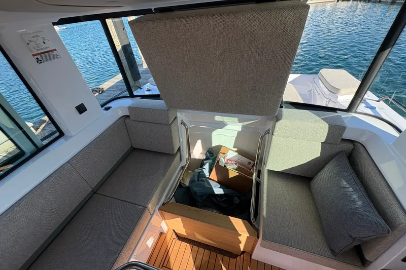 Slide: The Image of Interior of 2026 Axopar 37 XC Cross Cabin with open storage compartment and seating. - 55