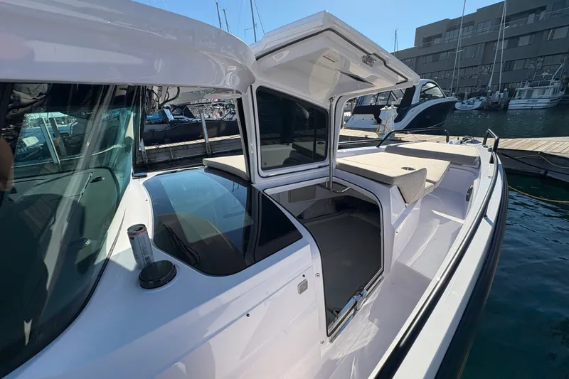 Slide: The Image of 2026 Axopar 37 XC Cross Cabin boat docked at marina, open cabin view. - 29
