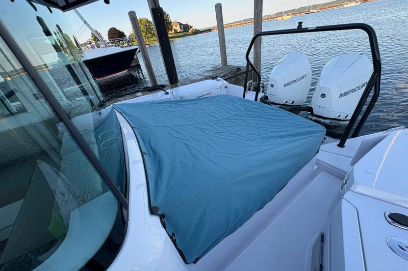 Slide: The Image of 2026 Axopar 37 XC Cross Cabin with Mercury engines docked by the water. - 67