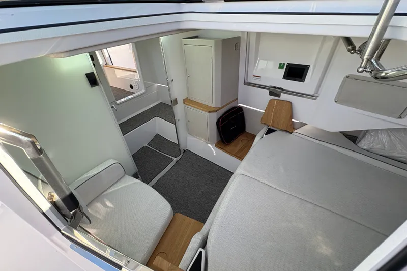 Slide: The Image of 2026 Axopar 37 XC Cross Cabin interior with modern seating and storage. - 32