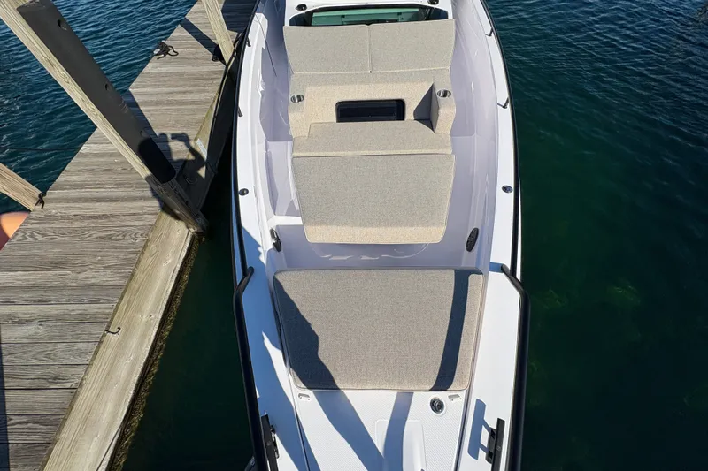 Slide: The Image of 2026 Axopar 37 XC Cross Cabin docked, showcasing sleek design and comfortable seating. - 26