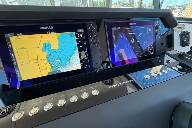 Slide: The Image of Dashboard of 2026 Axopar 37 XC Cross Cabin with Simrad navigation displays. - 39