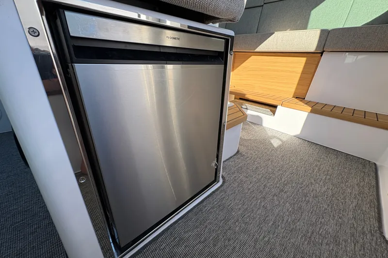Slide: The Image of 2026 Axopar 37 XC Cross Cabin interior with Dometic fridge and seating area. - 50