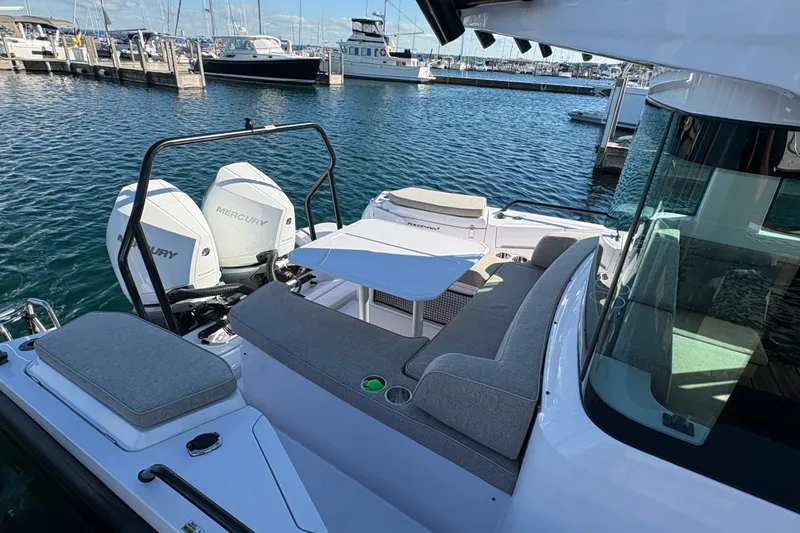 Slide: The Image of 2026 Axopar 37 XC Cross Cabin with Mercury engines docked at a marina. - 9