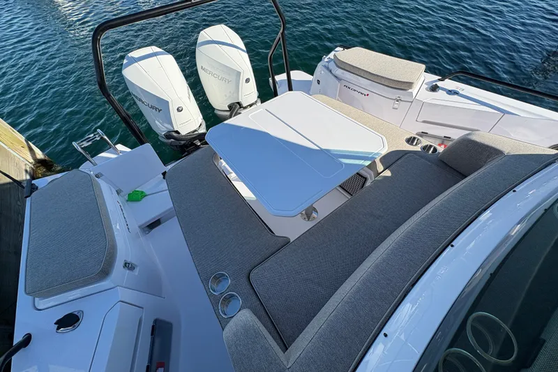 Slide: The Image of 2026 Axopar 37 XC Cross Cabin boat with twin Mercury engines and seating area. - 16