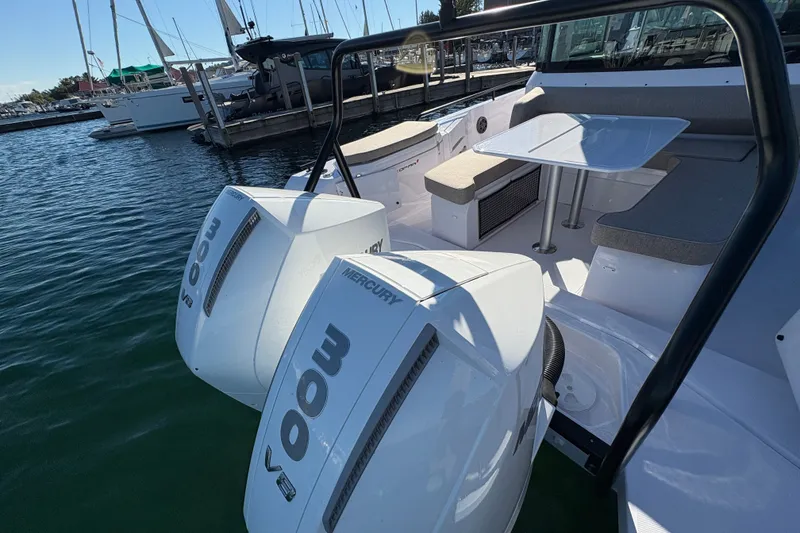 Slide: The Image of 2026 Axopar 37 XC Cross Cabin with dual Mercury 300 V8 engines at marina. - 12