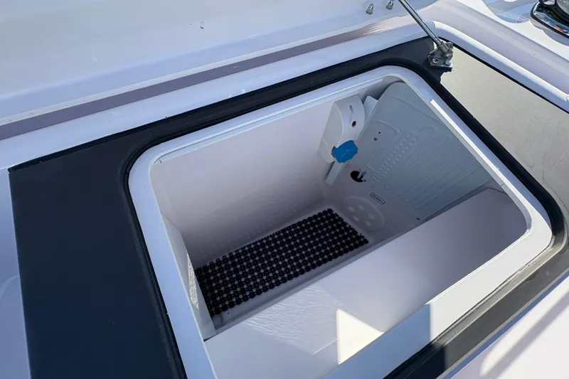Slide: The Image of Open storage compartment on 2026 Axopar 37 XC Cross Cabin boat. - 20