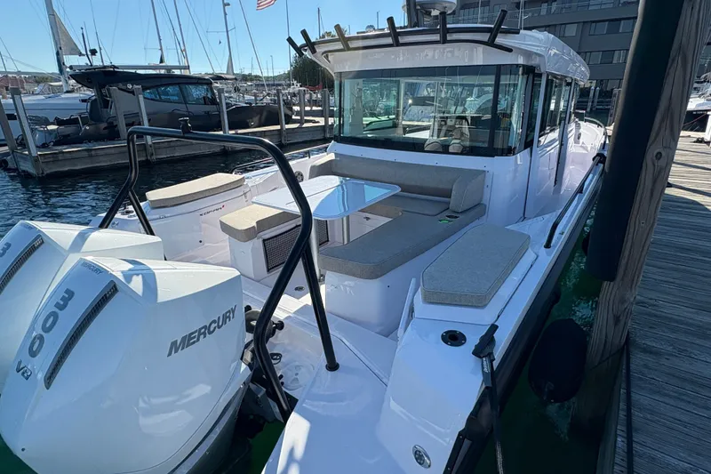 Slide: The Image of 2026 Axopar 37 XC Cross Cabin boat docked, featuring spacious seating and twin Mercury engines. - 10