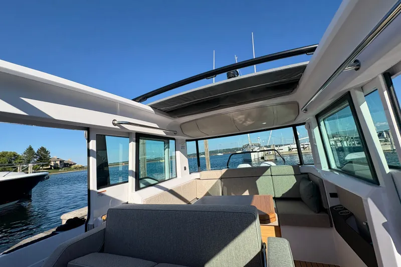 Slide: The Image of Interior view of 2026 Axopar 37 XC Cross Cabin boat, featuring spacious seating and panoramic windows. - 59