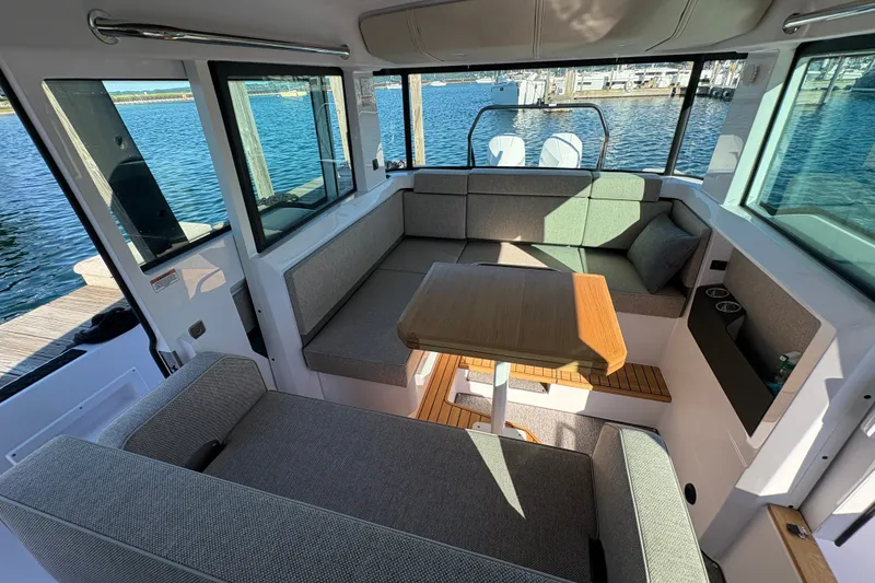 Slide: The Image of Interior of 2026 Axopar 37 XC Cross Cabin with seating and table, overlooking water. - 51