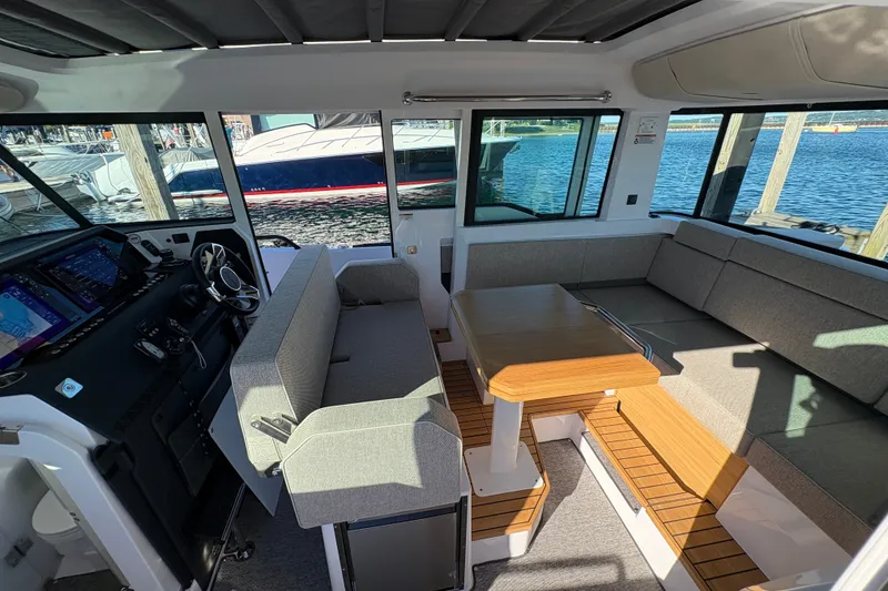 Slide: The Image of Interior of 2026 Axopar 37 XC Cross Cabin with seating and wooden table. - 48