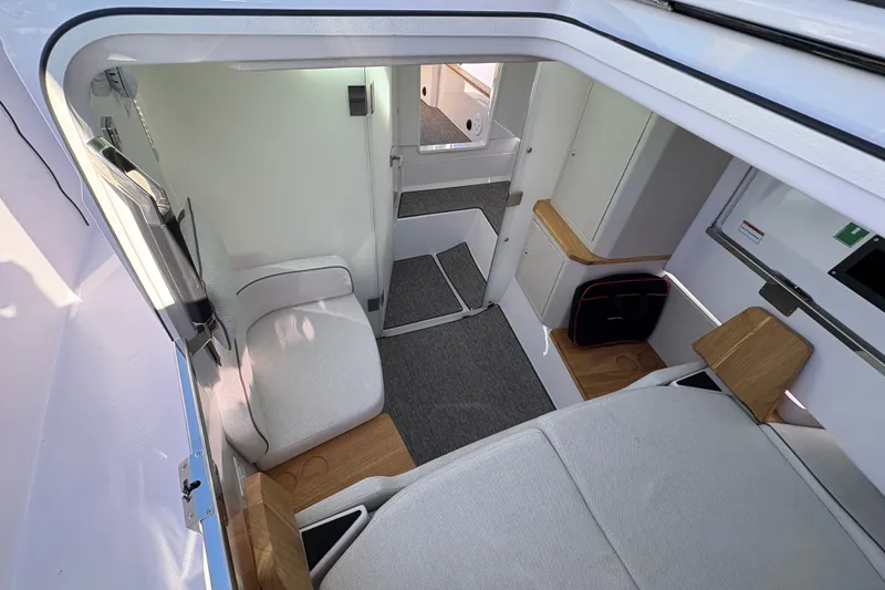 Slide: The Image of Interior of 2026 Axopar 37 XC Cross Cabin, featuring modern seating and storage. - 31