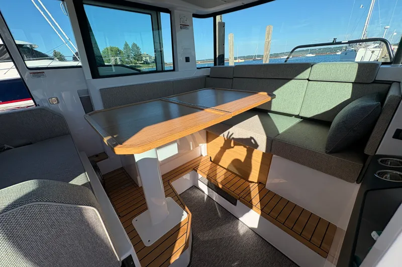 Slide: The Image of Interior of 2026 Axopar 37 XC Cross Cabin with seating and wooden table. - 52