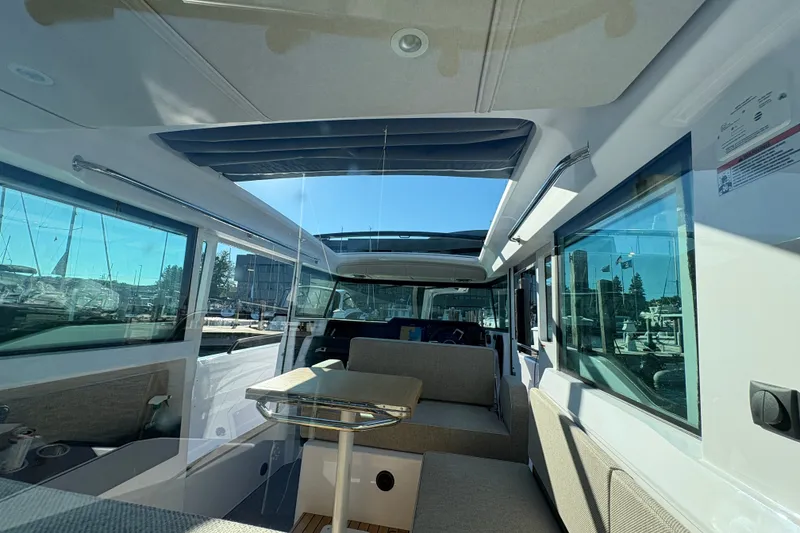 Slide: The Image of Interior of 2026 Axopar 37 XC Cross Cabin with modern seating and large windows. - 57