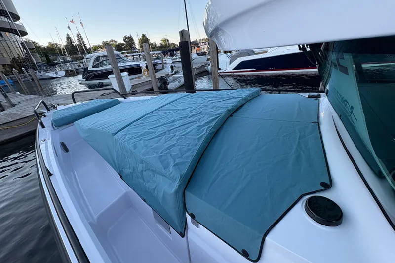Slide: The Image of 2026 Axopar 37 XC Cross Cabin boat docked, featuring a covered deck area. - 65