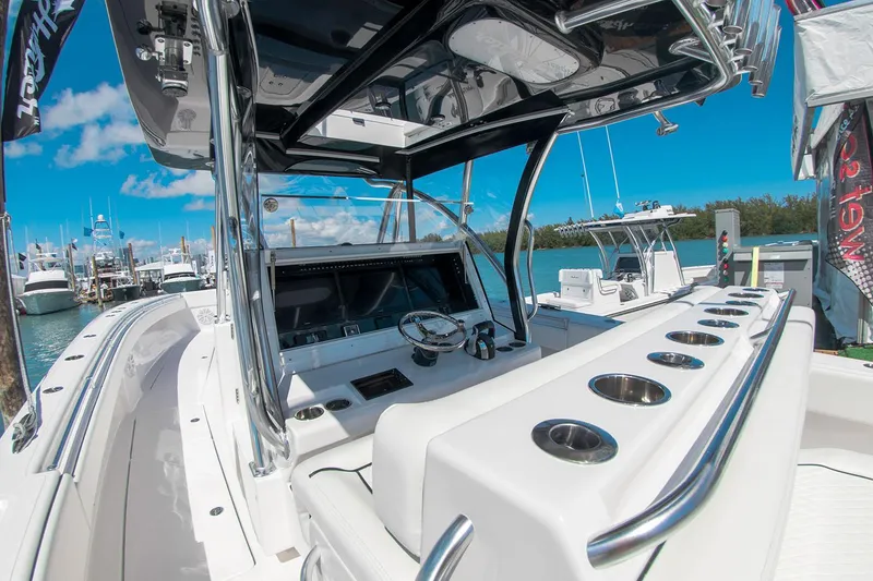 Slide: The Image of Manufacturer Provided Image: 2025 SeaHunter 41 CTS boat interior with sleek console and rod holders at marina. - 7