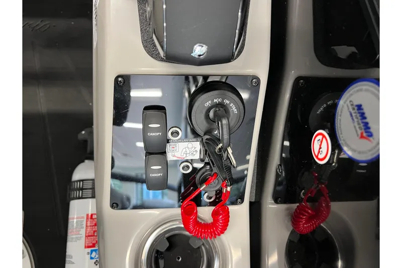 Slide: The Image of Control panel of 2025 Barletta Cabrio 22UC boat with ignition and canopy switches. - 10