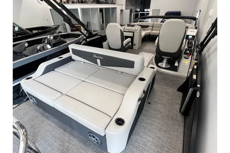 Slide: The Image of 2025 Barletta Cabrio 22UC pontoon boat interior with plush seating and modern design. - 4