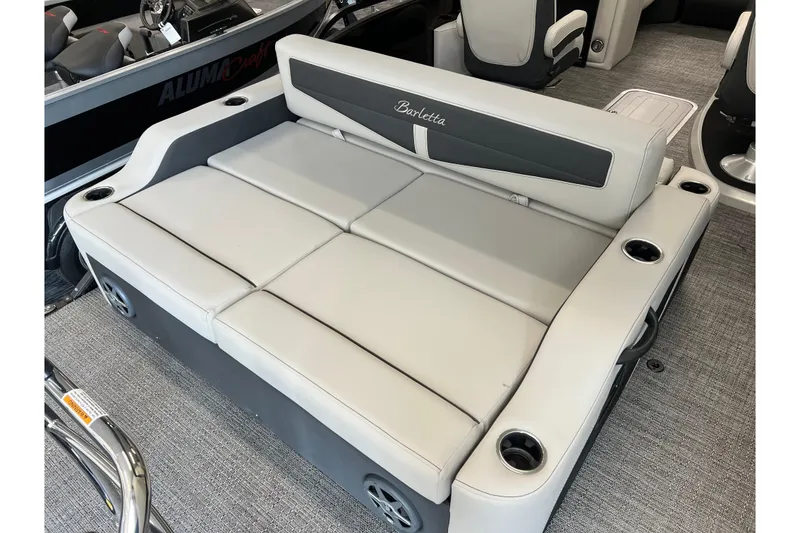 Slide: The Image of 2025 Barletta Cabrio 22UC boat interior with plush seating and integrated cup holders. - 5