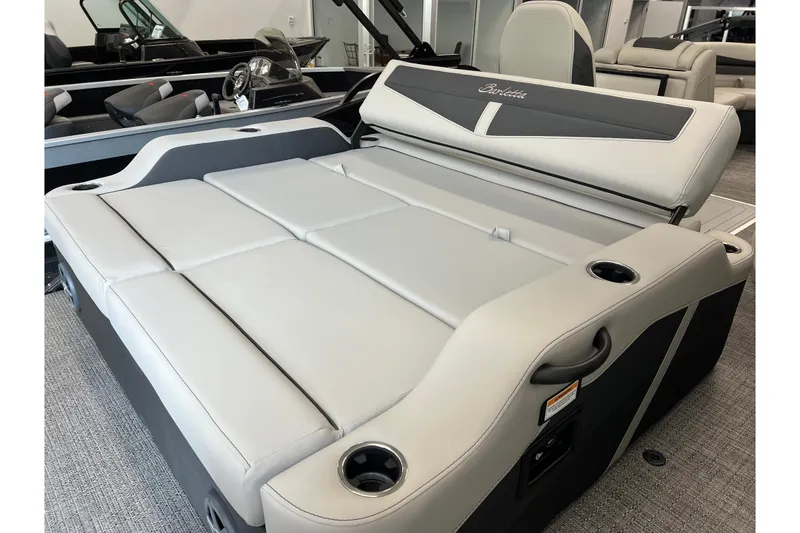 Slide: The Image of 2025 Barletta Cabrio 22UC boat interior with luxurious seating and cup holders. - 6