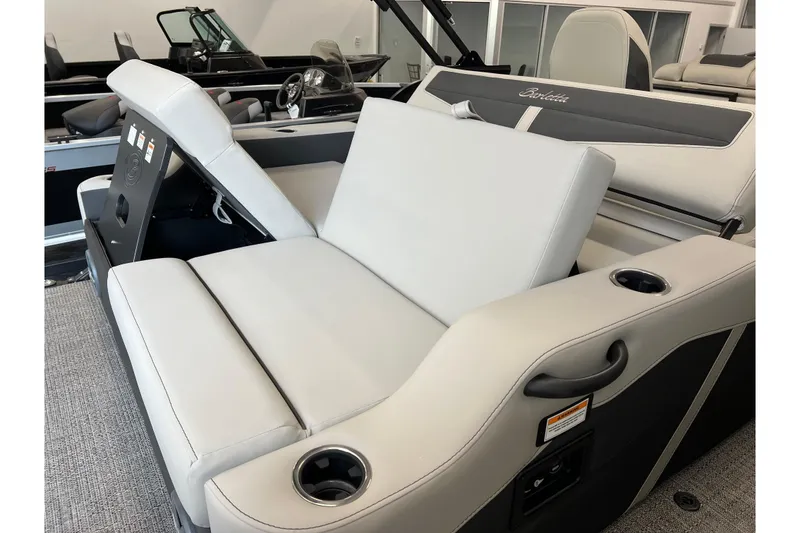 Slide: The Image of 2025 Barletta Cabrio 22UC boat interior with luxurious seating and cup holders. - 7