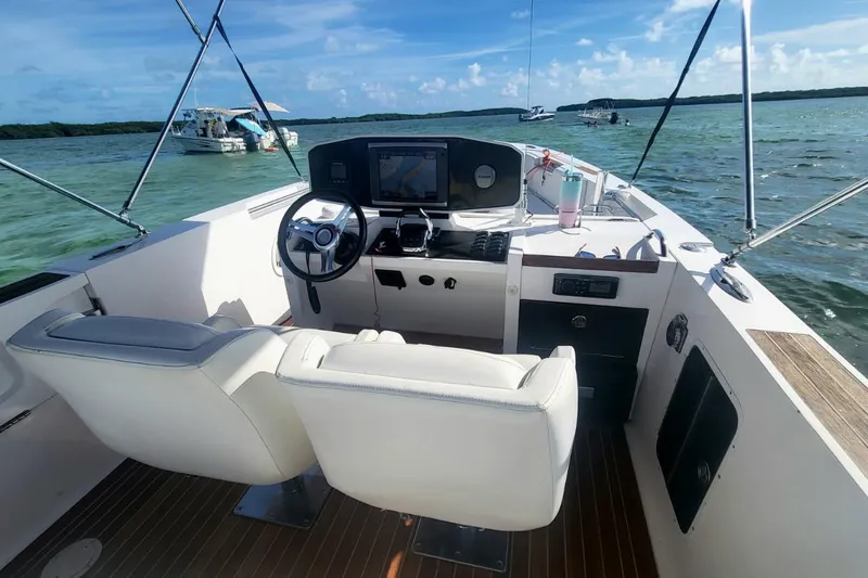 Slide: The Image of 2013 NOVURANIA OF AMERICA Chase 23 boat interior with steering wheel and navigation system. - 6