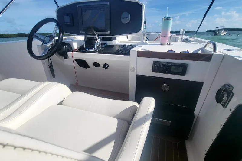 Slide: The Image of Interior view of 2013 NOVURANIA OF AMERICA Chase 23 boat cockpit with steering wheel and controls. - 7