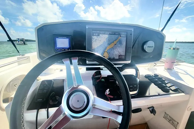 Slide: The Image of Steering console of 2013 NOVURANIA Chase 23 boat with navigation equipment and scenic water view. - 8