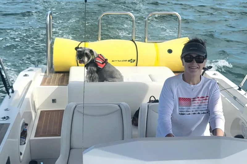 Slide: The Image of Person and dog on 2013 NOVURANIA Chase 23 boat, enjoying a sunny day on the water. - 9