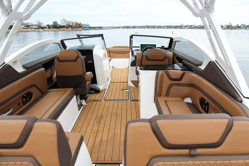 Slide: The Image of 2024 Yamaha 275 SD boat interior with luxurious brown seating and sleek design. - 4