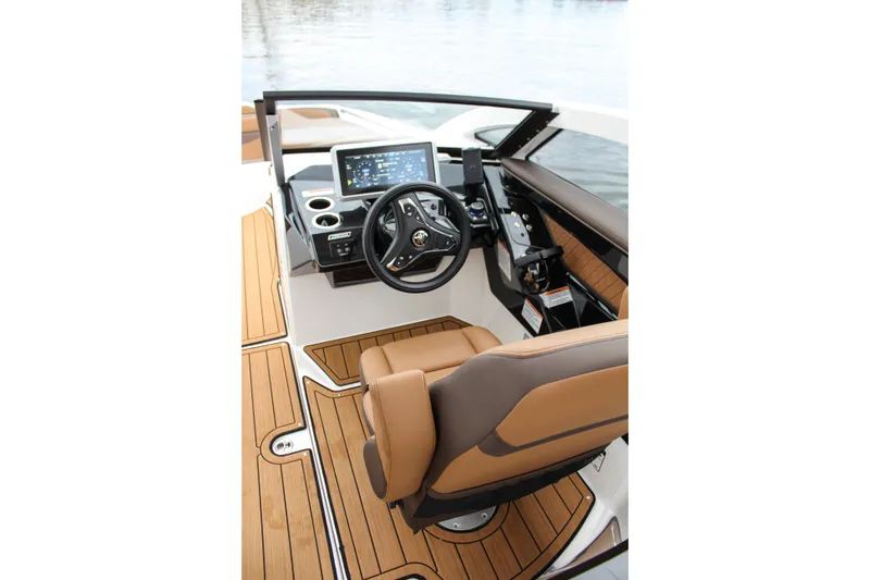 Slide: The Image of 2024 Yamaha 275 SD boat interior with modern dashboard and luxurious seating. - 7