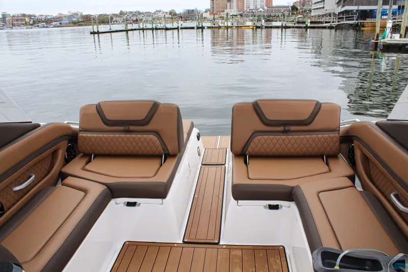 Slide: The Image of 2024 Yamaha 275 SD boat interior with luxurious brown seating and waterfront view. - 8