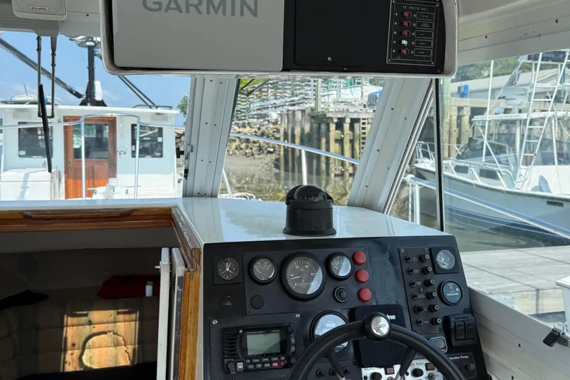Slide: The Image of 1994 Albin 28 Tournament Express cockpit with Garmin navigation system and control panel. - 13