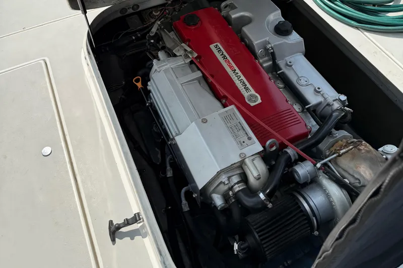 Slide: The Image of Engine compartment of a 1994 Albin 28 Tournament Express boat, featuring a Steyr Marine engine. - 16