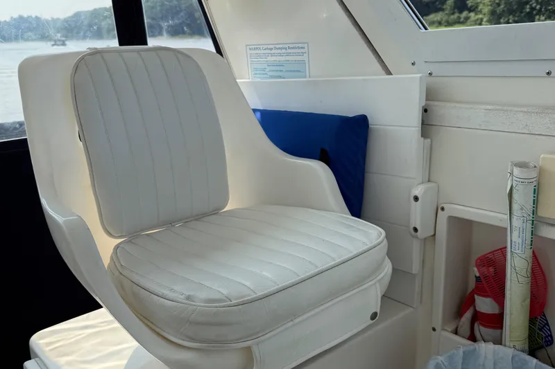 Slide: The Image of 1994 Albin 28 Tournament Express interior with white cushioned seat and window view. - 7