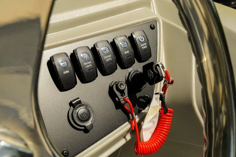 Slide: The Image of Control panel of 2026 Dockside Pontoons 22DQ with switches and safety lanyard. - 23