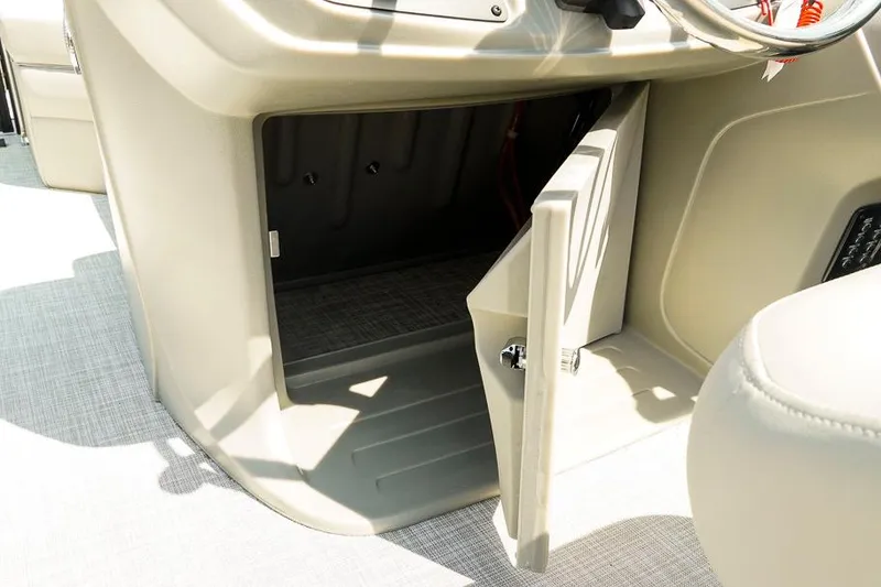 Slide: The Image of Open storage compartment on 2026 Dockside Pontoons 22DQ boat console. - 26