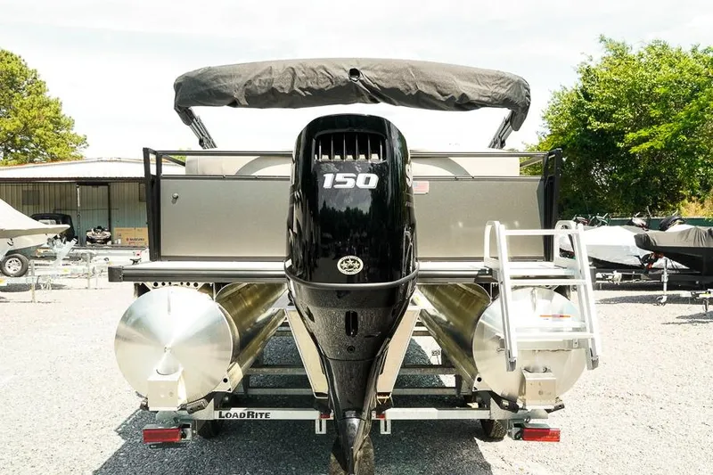 Slide: The Image of 2026 Dockside Pontoons 22DQ with 150 HP engine, parked outdoors on a trailer. - 3