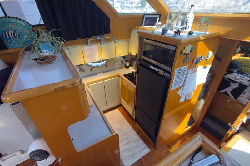 Slide: The Image of Cozy kitchen interior of a 1993 Novatec 44 yacht with wooden cabinetry and modern appliances. - 11