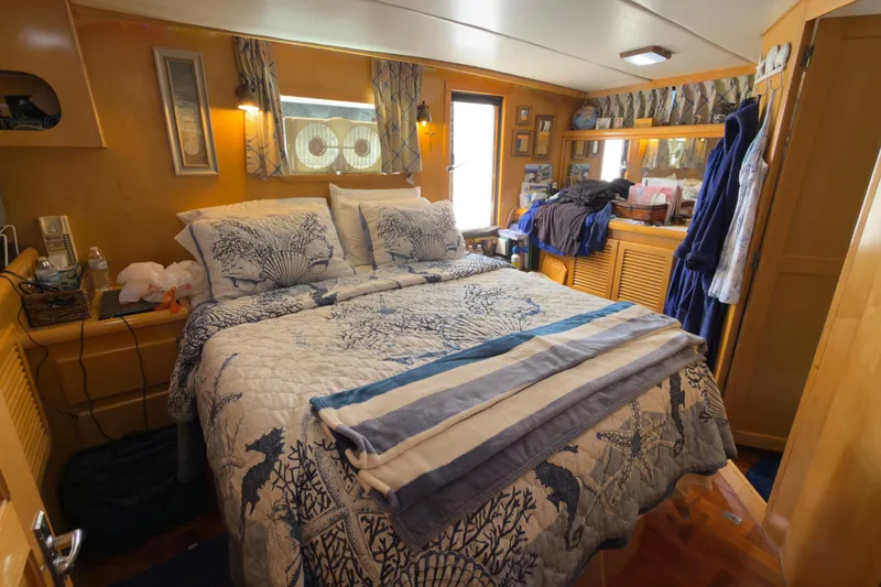 Slide: The Image of Cozy bedroom interior on a 1993 Novatec 44 boat with nautical-themed decor. - 13