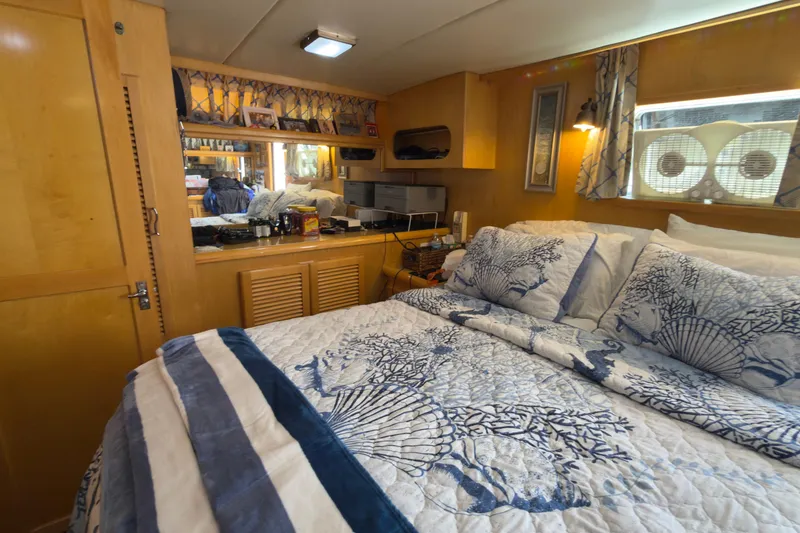 Slide: The Image of Cozy bedroom interior of 1993 Novatec 44 yacht with nautical-themed bedding and wooden cabinetry. - 14