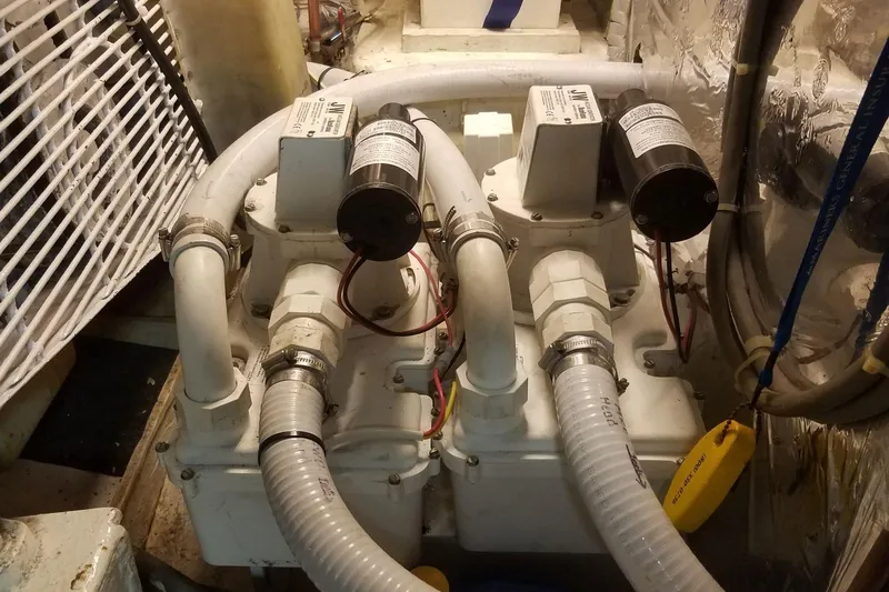 Slide: The Image of Engine room of a 1993 Novatec 44 yacht with dual pumps and hoses. - 17