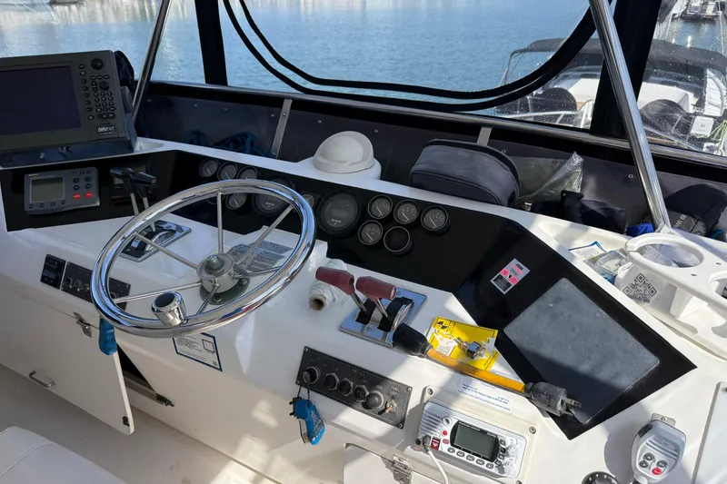 Slide: The Image of Cockpit of a 1993 Novatec 44 boat with steering wheel and navigation equipment. - 7