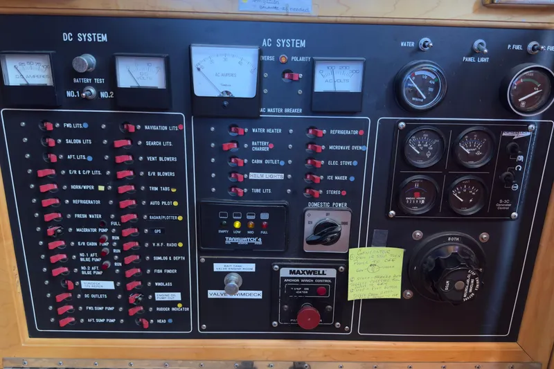 Slide: The Image of Control panel of a 1993 Novatec 44 boat, featuring DC and AC systems with gauges and switches. - 8