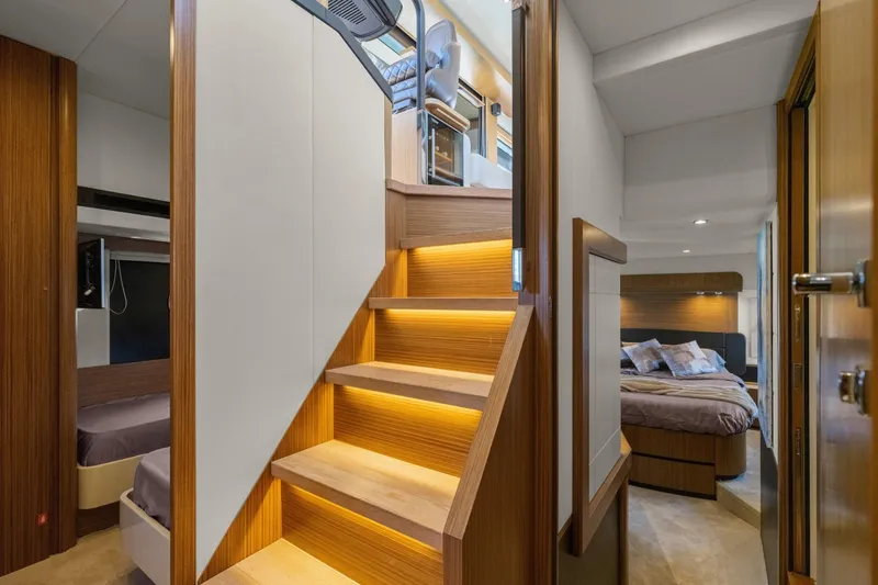 Slide: The Image of Luxurious interior of 2018 Absolute Navetta 52 yacht featuring elegant wooden staircase and cozy bedrooms. - 12