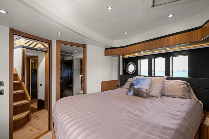 Slide: The Image of Luxurious bedroom interior of 2018 Absolute Navetta 52 yacht, featuring elegant wood finishes. - 15