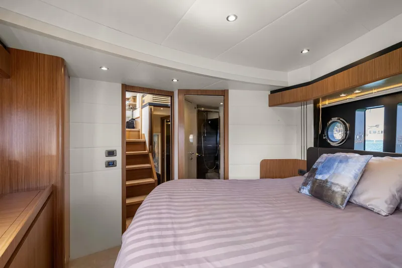 Slide: The Image of Luxurious bedroom interior of 2018 Absolute Navetta 52 yacht, featuring elegant wood finishes. - 16