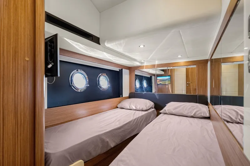 Slide: The Image of Interior of 2018 Absolute Navetta 52 yacht with twin beds and porthole windows. - 17
