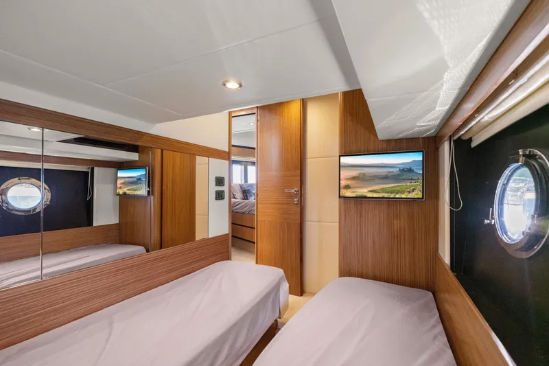 Slide: The Image of Luxurious cabin interior of 2018 Absolute Navetta 52 yacht with twin beds and porthole window. - 18